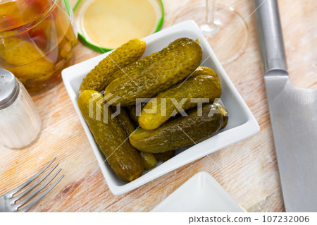 Marinated cucumbers pods served on plate Marinated cucumbers pods served on plate 107232006