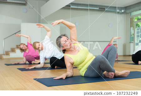 Group of active mature women practicing yoga 107232249