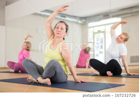 Aged women are sitting in a lotus pose Aged women are sitting in a lotus pose 107232726