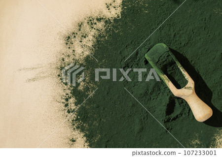 Natural organic green spirulina algae powder in wooden spoon on neutral background. Chlorella seaweed vegan superfood supplement source and detox. Copy space Healthy nutritional antioxidant Natural organic green spirulina algae powder in wooden spoon on neutral background. Chlorella seaweed vegan superfood supplement source and detox. Copy space Healthy nutritional antioxidant 107233001