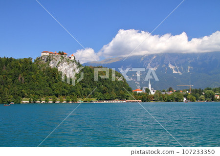 Lake Bled in Slovenia, Southern Europe: Bled Castle and the Julian Alps built on the cliffs of the turquoise lakeshore 107233350