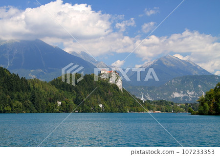 Lake Bled in Slovenia, Southern Europe: Bled Castle and the Julian Alps built on the cliffs of the turquoise lakeshore 107233353