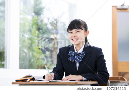 High school girl taking class, smiling 107234213