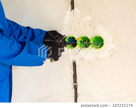 Professional electrician working on home electrical system Professional electrician working on home electrical system 107235174
