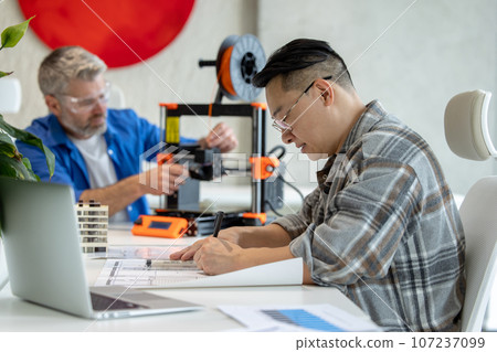 Architects making house model using 3D printer, FDM technology for architectural use. 107237099