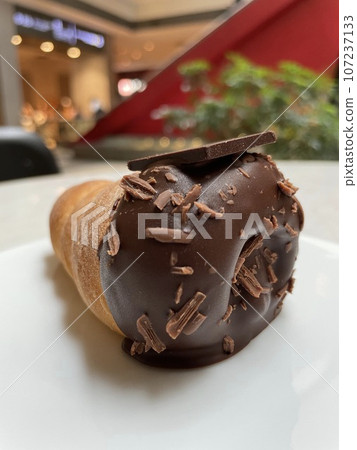Chocolate Cornet: A spiral-shaped sweet bread filled with chocolate cream. Chocolate Cornet: A spiral-shaped sweet bread filled with chocolate cream. 107237133