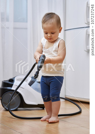 baby girl play with professional cleaning steam generator, cute little helper baby girl play with professional cleaning steam generator, cute little helper 107237248