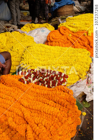 Flowers and garlands for sale at the flower market in the shadow of the Haora Bridge in Kolkata 107237268