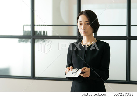 Photo of a woman attending a funeral Photo of a woman attending a funeral 107237335