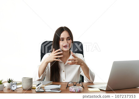 beautiful businesswoman talking on video call to client beautiful businesswoman talking on video call to client 107237353