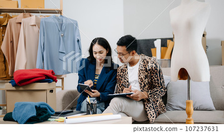 Diverse female fashion designers at work with tailor centimeters on necks and holds tablet and smartphone. independent creative design business. . 107237631