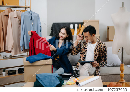 Diverse female fashion designers at work with tailor centimeters on necks and holds tablet and smartphone. independent creative design business. . 107237633