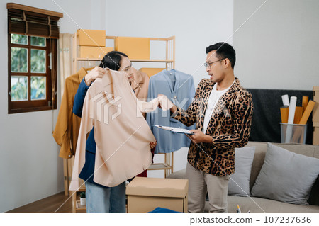 Diverse female fashion designers at work with tailor centimeters on necks and holds tablet and smartphone. independent creative design business. . 107237636