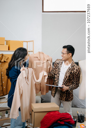 Diverse female fashion designers at work with tailor centimeters on necks and holds tablet and smartphone. independent creative design business. . Diverse female fashion designers at work with tailor centimeters on necks and holds tablet and smartphone. independent creative design business. . 107237689