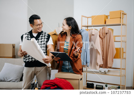 Diverse female fashion designers at work with tailor centimeters on necks and holds tablet and smartphone. independent creative design business. . 107237783