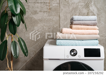 Stacked towels on washing machine in laundry room Stacked towels on washing machine in laundry room 107238292