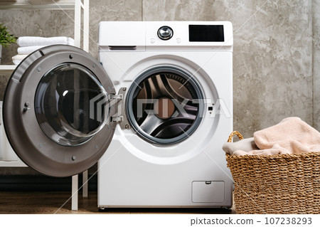 Washing machine in a gray modern laundry room 107238293