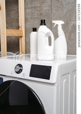 Washing liquid detergents on washing machine in a laundry room 107238398