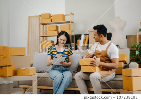 Starting small businesses SME owners, two check online orders Selling products working with boxs freelance work at home office using tablet and laptop marketing, packaging, concept Starting small businesses SME owners, two check online orders Selling products working with boxs freelance work at home office using tablet and laptop marketing, packaging, concept 107239193