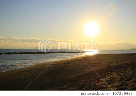 Sunset over the sea and sandy beach 107239482