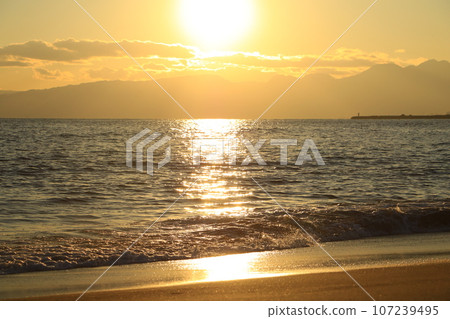 Sunset over the sea and sandy beach 107239495