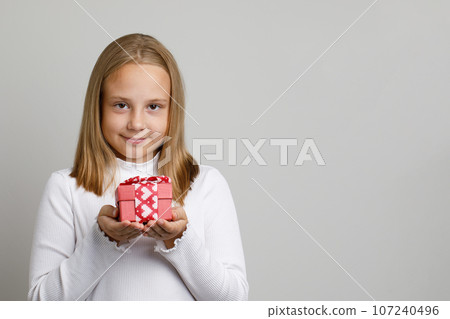 Cute pretty kid girl with gift on white background Cute pretty kid girl with gift on white background 107240496