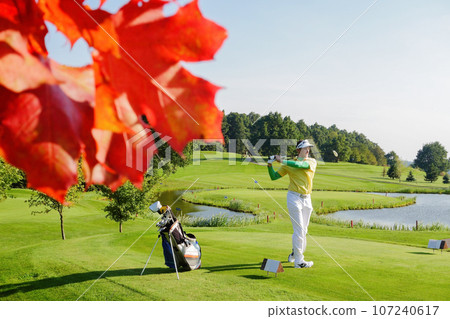 Man playing golf during colorful autumn 107240617