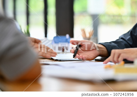 Cropped shot of senior woman talking and discussing financial plan or investment plan with financial adviser Cropped shot of senior woman talking and discussing financial plan or investment plan with financial adviser 107241956