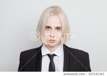 Fashion beauty portrait of beautiful blonde business woman wearing suit and tie on white background Fashion beauty portrait of beautiful blonde business woman wearing suit and tie on white background 107242361