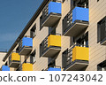 Modern facade building with yellow and blue balconies 107243042
