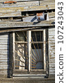 Old broken window with metal grid 107243043