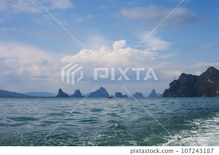 Floating yacht in Andaman sea and islands silhouettes, Thailand Floating yacht in Andaman sea and islands silhouettes, Thailand 107243187
