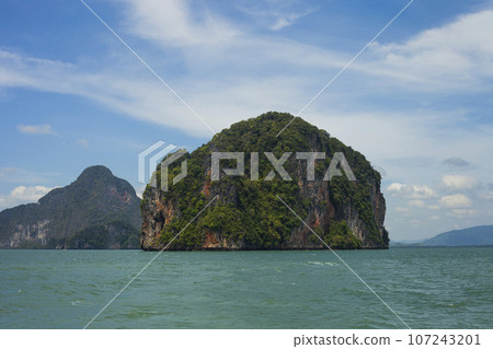 Seascape with green island against blue sky, Phuket, Thailand Seascape with green island against blue sky, Phuket, Thailand 107243201