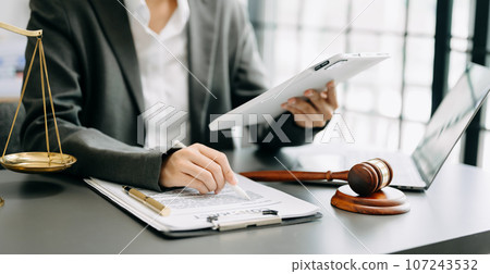 justice and law concept. Male judge in a courtroom the gavel, working with smart phone and laptop and digital tablet computer on table . justice and law concept. Male judge in a courtroom the gavel, working with smart phone and laptop and digital tablet computer on table . 107243532