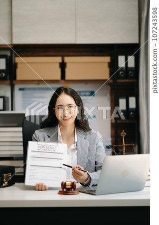 justice and law concept. Female judge in a courtroom on wooden table and Counselor or Male lawyer working in modern office. . justice and law concept. Female judge in a courtroom on wooden table and Counselor or Male lawyer working in modern office. . 107243598