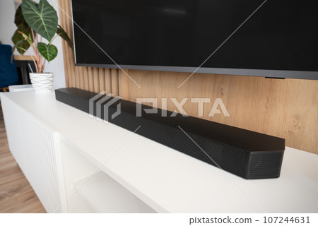 Soundbar in a modern home. Listening to music Soundbar in a modern home. Listening to music 107244631