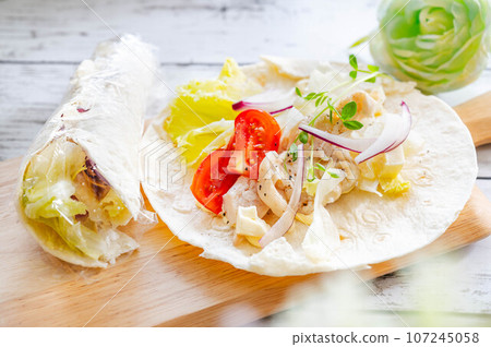 Making chicken wraps Making chicken wraps 107245058
