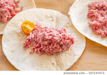 ground meat on tortilla dough 107245073