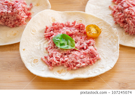 ground meat on tortilla dough 107245074