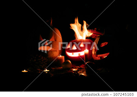Halloween pumpkin fire smile and scary eyes for party night. View of scary Halloween pumpkin with Halloween pumpkin fire smile and scary eyes for party night. View of scary Halloween pumpkin with 107245103