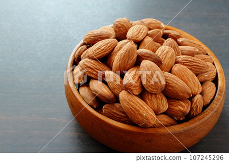 Almonds in wooden tableware Almonds in wooden tableware 107245296