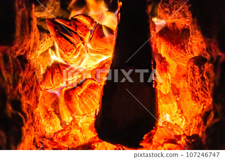 Beautiful old fireplace with light flame fire for heating building room 107246747