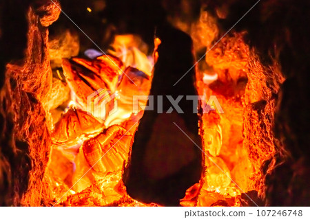 Beautiful old fireplace with light flame fire for heating building room Beautiful old fireplace with light flame fire for heating building room 107246748