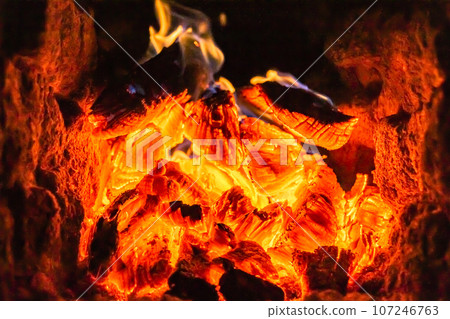 Beautiful old fireplace with light flame fire for heating building room 107246763