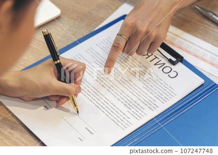 Close up Team Businesswoman hands partners sign contract with success business deal. Diversity Businesswoman teams handshake together. Partnership teamwork meeting signing contract business concept 107247748
