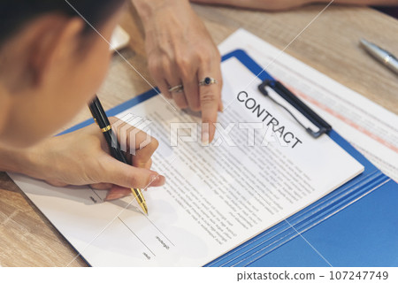 Close up Team Businesswoman hands partners sign contract with success business deal. Diversity Businesswoman teams handshake together. Partnership teamwork meeting signing contract business concept 107247749