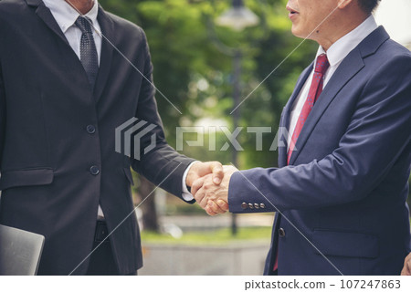 Diversity Business Partner meeting trust in teamwork and partnership businessman, businesswoman talking together in modern city. Asian coworker team meeting with Business People Working Together Team 107247863