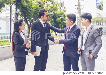 Diversity Business Partner meeting trust in teamwork and partnership businessman, businesswoman talking together in modern city. Asian coworker team meeting with Business People Working Together Team 107247864