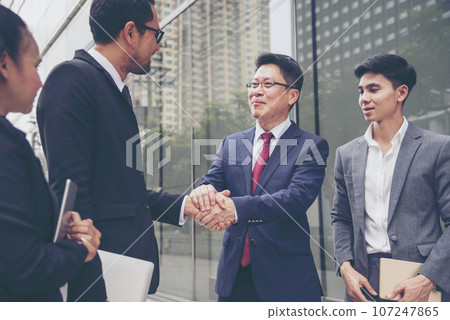 Diversity Business Partner meeting trust in teamwork and partnership businessman, businesswoman talking together in modern city. Asian coworker team meeting with Business People Working Together Team 107247865