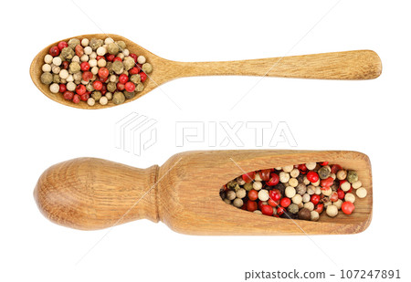 mix of peppercorn in wooden spoon isolated on white background. Top view. Flat lay mix of peppercorn in wooden spoon isolated on white background. Top view. Flat lay 107247891